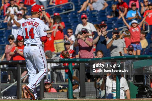 Washington Nationals third baseman Mark Reynolds responds to the crows after pitching for the last out in the ninth inning during the game between...