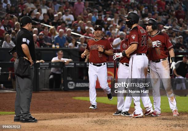 Pollock of the Arizona Diamondbacks is being held back by teammate Steven Souza Jr after being ejected for arguing balls and strikes with home plate...