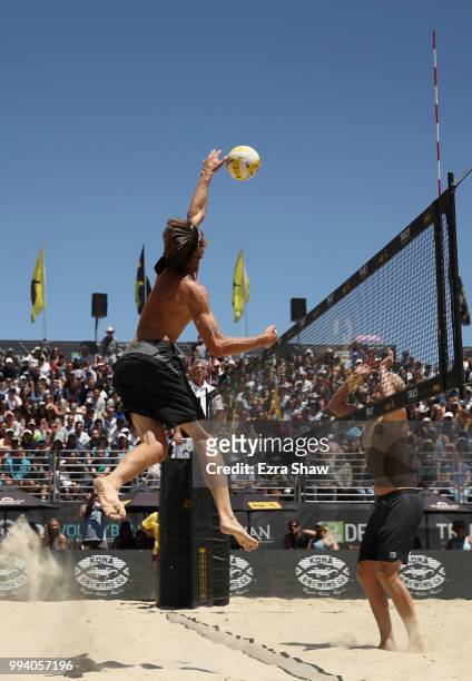 Ed Ratledge spikes the ball on Chase Budinger in the finals of the Men's AVP San Francisco Open at Pier 30-32 on July 8, 2018 in San Francisco,...