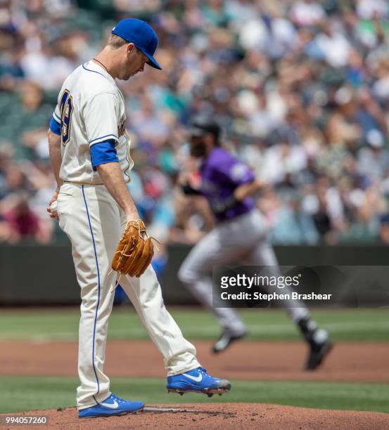 Starting pitcher Wade LeBlanc of the Seattle Mariners reacts after giving up a solo home run to Charlie Blackmon of the Colorado Rockies during the...