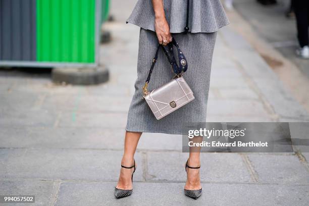 A Diorama silver dior bag, gray shoes, a gray skirt , outside News Photo  - Getty Images