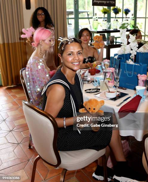 Dorys Erving waits to donate a teddy bear during Coach Woodson Invitational presented by MGM Resorts International, a PGD Global production, at...