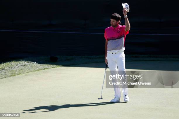 Bubba Watson waves to the crowd after finishing on the 18th hole during the final round of A Military Tribute At The Greenbrier held at the Old White...