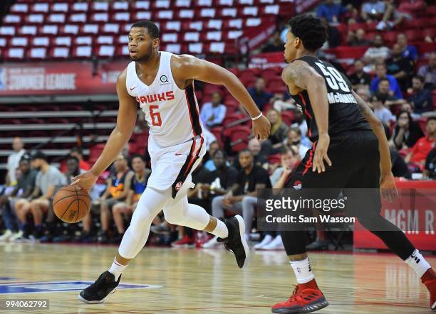 Omari Spellman of the Atlanta Hawks dribbles against KJ McDaniels of the Portland Trail Blazers during the 2018 NBA Summer League at the Thomas &...