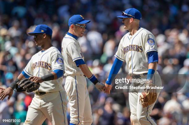 Jean Segura of the Seattle Mariners, Ichiro Suzuki of the Seattle Mariners and Ryon Healy of the Seattle Mariners celebrate after a game against the...