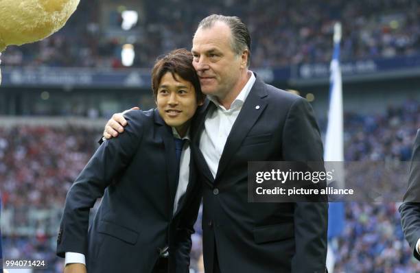 Schalke's chairman Clemens Toennies says goodbye to former Schalke-player Atsuto Uchida before the German Bundesliga soccer match between Schalke 04...