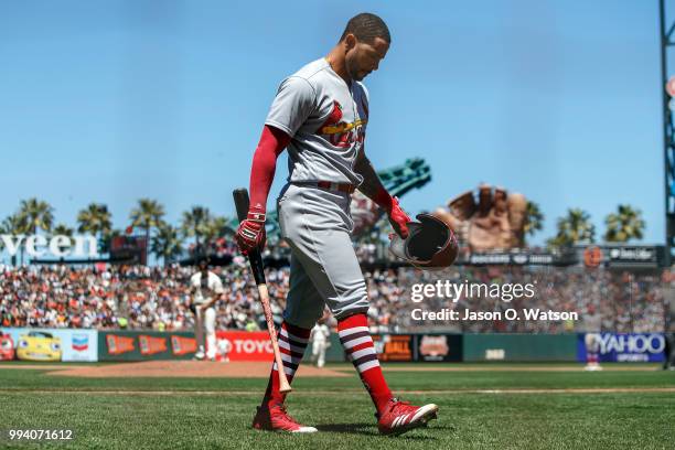 Tommy Pham of the St. Louis Cardinals returns to the dugout after striking out against the San Francisco Giants during the fifth inning at AT&T Park...