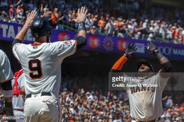 Pablo Sandoval of the San Francisco Giants is congratulated by Brandon Belt after hitting a three run home run against the St. Louis Cardinals during...