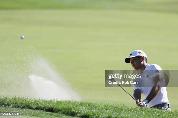 Xander Schauffele hits out of the bunker on the 17th hole during the final round of A Military Tribute At The Greenbrier held at the Old White TPC...