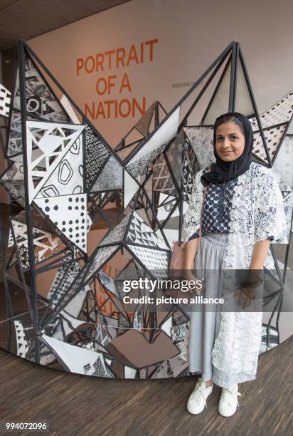 The artist Eman Alhashemi stands next toher installation "Around" at the exhibition "Portrait of a Nation" at the "me Collectors Room" in Berlin,...