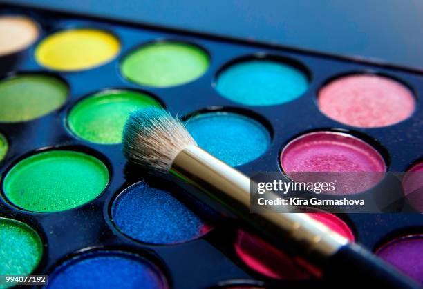 make-up brush and eyeshadow palette over black close up. - black eyeshadow stock pictures, royalty-free photos & images