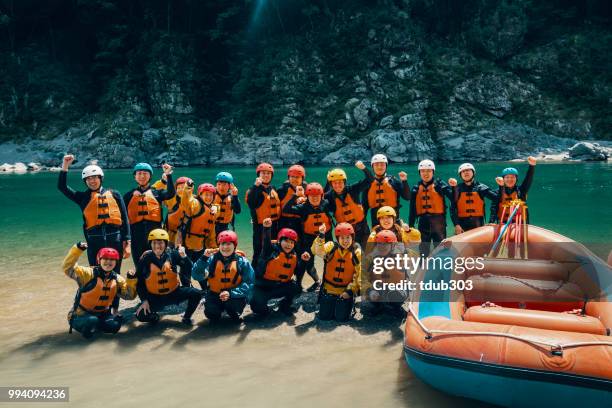 Large group of men and women preparing to go white water river rafting