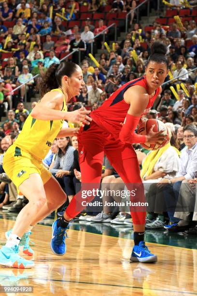 Natasha Cloud of the Washington Mystics handles the ball against Sue Bird of the Seattle Storm on July 8, 2018 at Key Arena in Seattle, Washington....