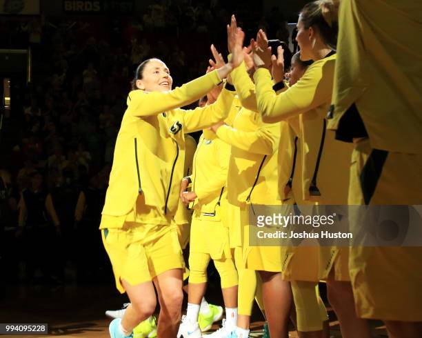 Sue Bird of the Seattle Storm high-fives teammates as she is introduced before the game against the Washington Mystics on July 8, 2018 at Key Arena...
