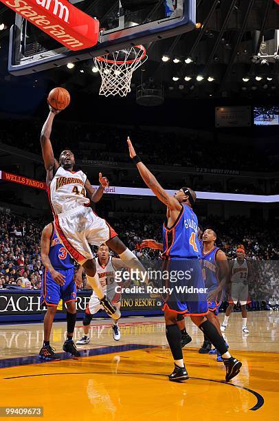 Anthony Tolliver of the Golden State Warriors shoots a layup against J.R. Giddens of the New York Knicks during the game at Oracle Arena on April 2,...