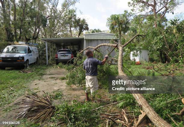 Resident tries to clear his property from a fallen tree by Hurricane 'Irma' in Bonita Springs, US, 11 September 2017. The storm caused massive...