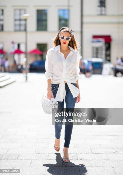 Alexandra Lapp wearing La Chemise Olhao in off white by Jacquemus, blue AG Adriano Goldschmied denim, white Inez leather sandals by Saint Laurent,...