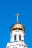 Golden cross on bell tower dome