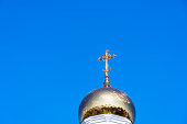 Golden cross on bell tower dome
