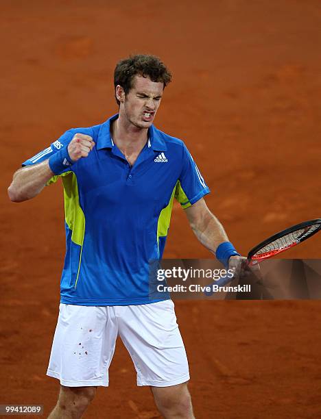 Andy Murray of Great Britain shows his frustration as he prepares to punch his racket after losing the first set against David Ferrer of Spain in...