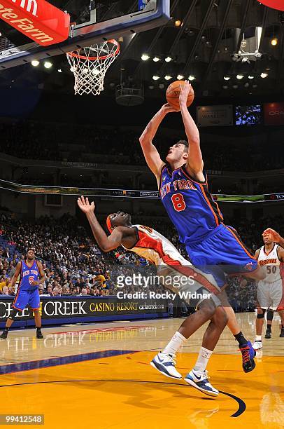 Danilo Gallinari of the New York Knicks goes up for a shot against Anthony Morrow of the Golden State Warriors during the game at Oracle Arena on...