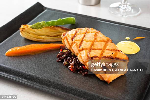 salmon steak with black rice - macrobiotic diet stock pictures, royalty-free photos & images