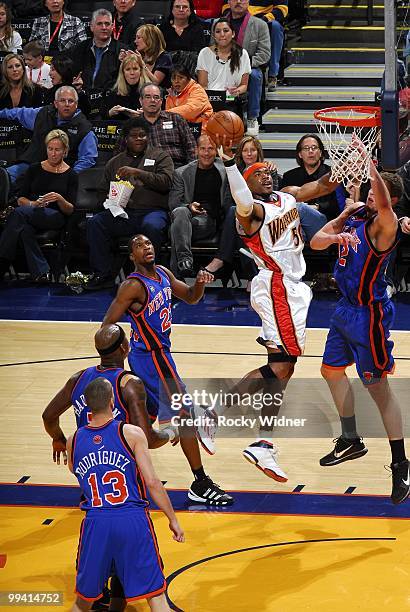 Corey Maggette of the Golden State Warriors goes up for a shot against Sergio Rodriguez, Al Harrington, Toney Douglas and David Lee of the New York...