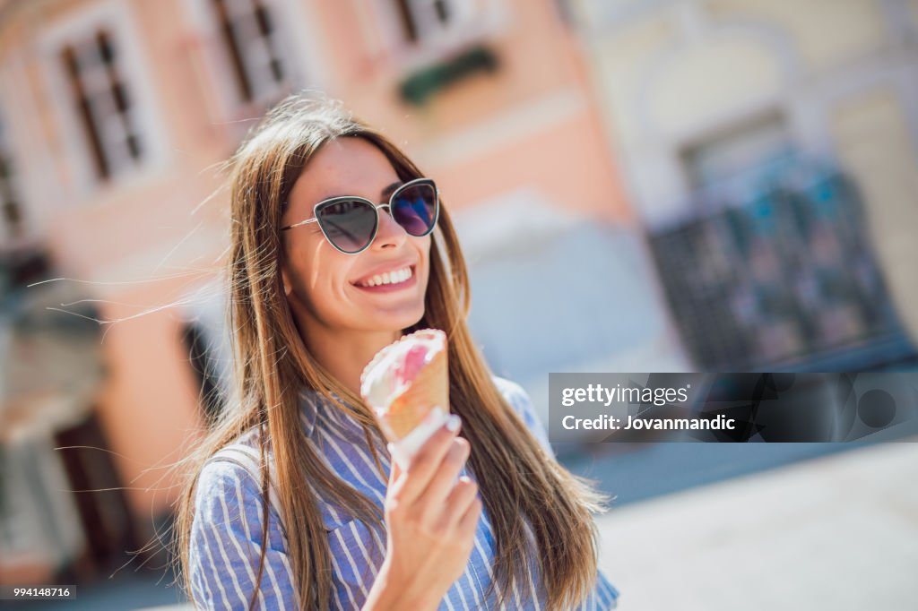 Happy girl enjoying ice cream outdoors