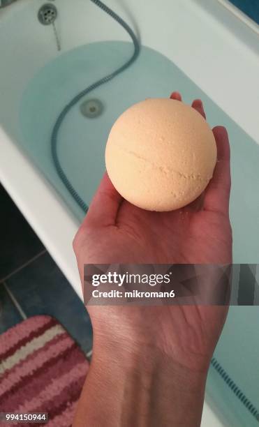 preparing relaxing baths using bath bomb - mikroman6 imagens e fotografias de stock