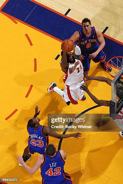 Ronny Turiaf of the Golden State Warriors dunks against Toney Douglas, Danilo Gallinari and David Lee of the New York Knicks during the game at...