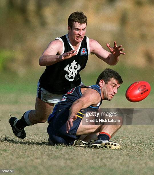 Darren Bowden of the Western Suburbs and Travis Hall of the Eagles contest the ball during the Sydney AFL match between the East Coast Eagles and...