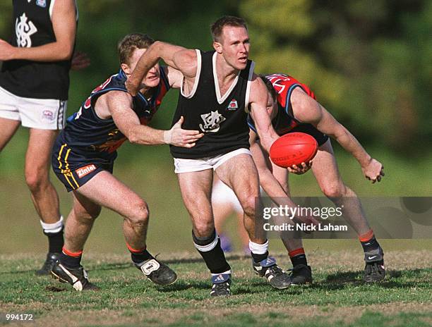 Ted Fenton of the Western Suburbs attempts to handpass during the Sydney AFL match between the East Coast Eagles and Western Suburbs held at Roger...