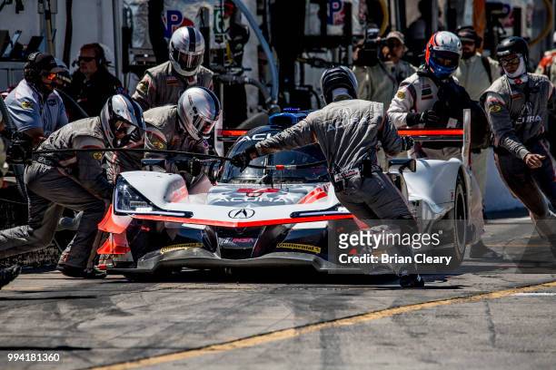 The Acura DPi of Helio Castroneves, of Brazil, and Ricky Taylor makes a pit stop during the IMSA WeatherTech race at Canadian Tire Motorsport Park on...