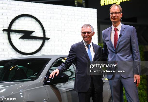 Carlos Tavares , CEO of the PSA Group and the CEO of Opel Michael Lohscheller present the new Opel Insignia GSi at the Opel stand at the...