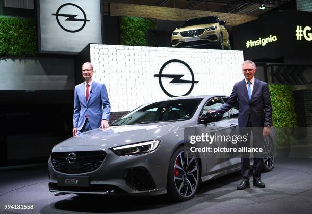 Carlos Tavares , CEO of the PSA Group and the CEO of Opel Michael Lohscheller present the new Opel Insignia GSi at the Opel stand at the...