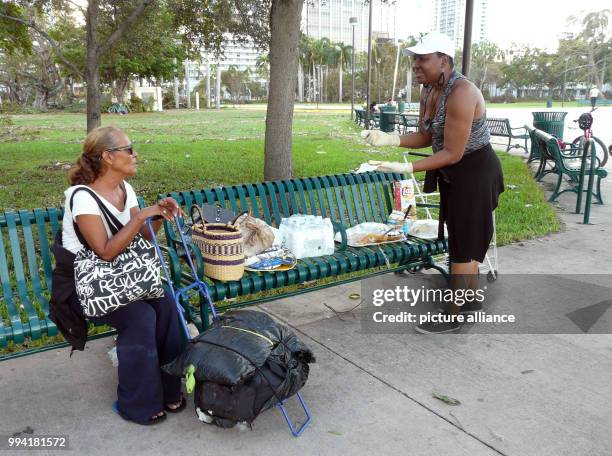 Yanick Landess gives out sandwiches, crisps and water to people in need at the promenade in Miami, US, 11 September 2017. At the day after Hurricane...