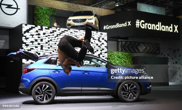 Parcour runner in action in front of the new Opel Grandland X at the Opel stand at the Internationale Automobil-Ausstellung in Frankfurt am Main,...