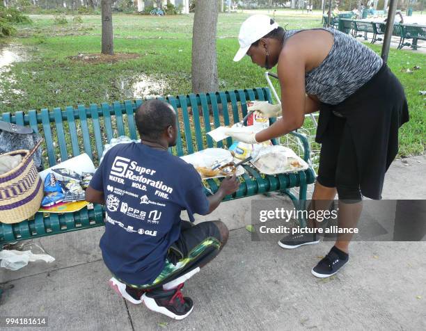 Yanick Landess gives out sandwiches, crisps and water to people in need at the promenade in Miami, US, 11 September 2017. At the day after Hurricane...