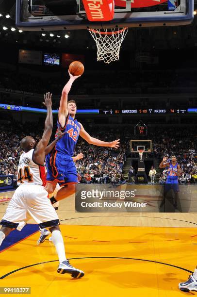 David Lee of the New York Knicks goes up for a shot against Anthony Tolliver of the Golden State Warriors during the game at Oracle Arena on April 2,...