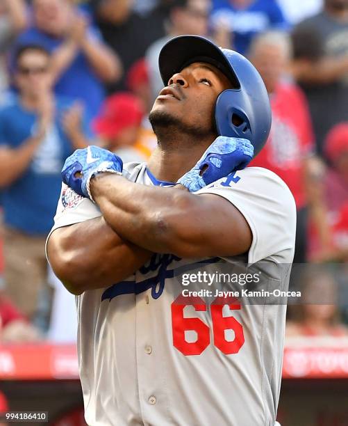 Yasiel Puig of the Los Angeles Dodgers crosses the plate on his three-run home run off of Andrew Heaney of the Los Angeles Angels of Anaheim in the...