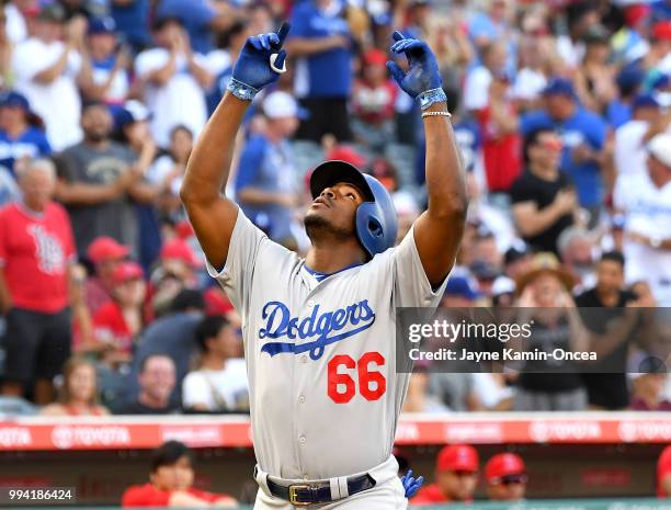 Yasiel Puig of the Los Angeles Dodgers crosses the plate on his three-run home run off Andrew Heaney of the Los Angeles Angels of Anaheim in the...