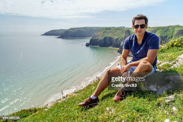 single brazilian man lifestyle portrait at beach - dyfed stock pictures, royalty-free photos & images