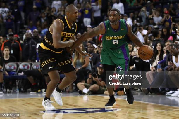 Qyntel Woods of 3 Headed Monsters controls the ball against Metta World Peace of Killer 3s during week three of the BIG3 three on three basketball...