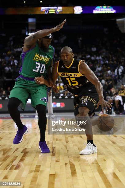 Metta World Peace of Killer 3s drives with the ball against Reggie Evans of 3 Headed Monsters during week three of the BIG3 three on three basketball...