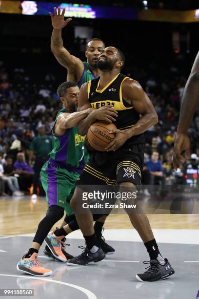 Alan Anderson of Killer 3s is fouled by Mahmoud Abdul-Rauf of 3 Headed Monsters during week three of the BIG3 three on three basketball league game...