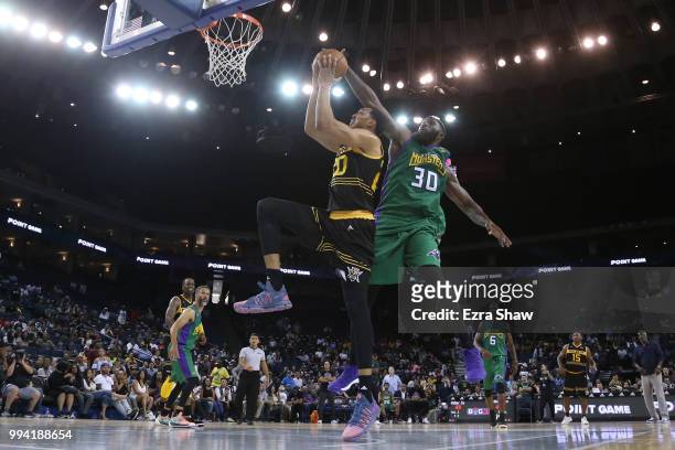 Reggie Evans of 3 Headed Monsters defends a shot by Ryan Hollins of Killer 3s during week three of the BIG3 three on three basketball league game at...