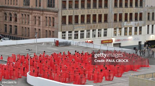 Over 200 people pose partially naked on a shopping centre rooftop car park as part of US photographer Spencer Tunicks latest artwork in Melbourne on...