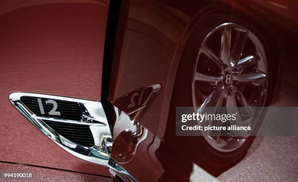 The tyre of the New Continental GT reflects in an open car door at the stand of Bentley at the International Automobile Fair in Frankfurt/Main,...