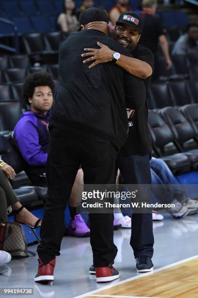 Recording artists LL Cool J and Ice Cube hug during week three of the BIG3 three on three basketball league game at ORACLE Arena on July 6, 2018 in...