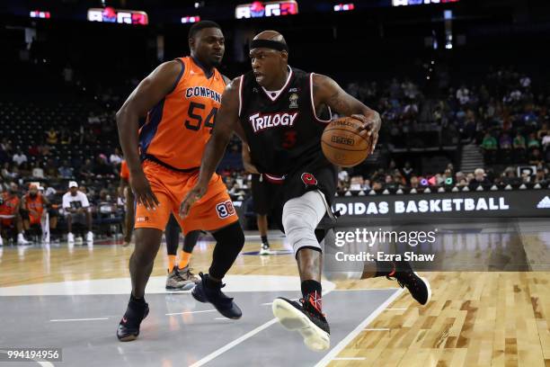 Al Harrington of Trilogy drives with the ball against Jason Maxiell of 3's Company during week three of the BIG3 three on three basketball league...